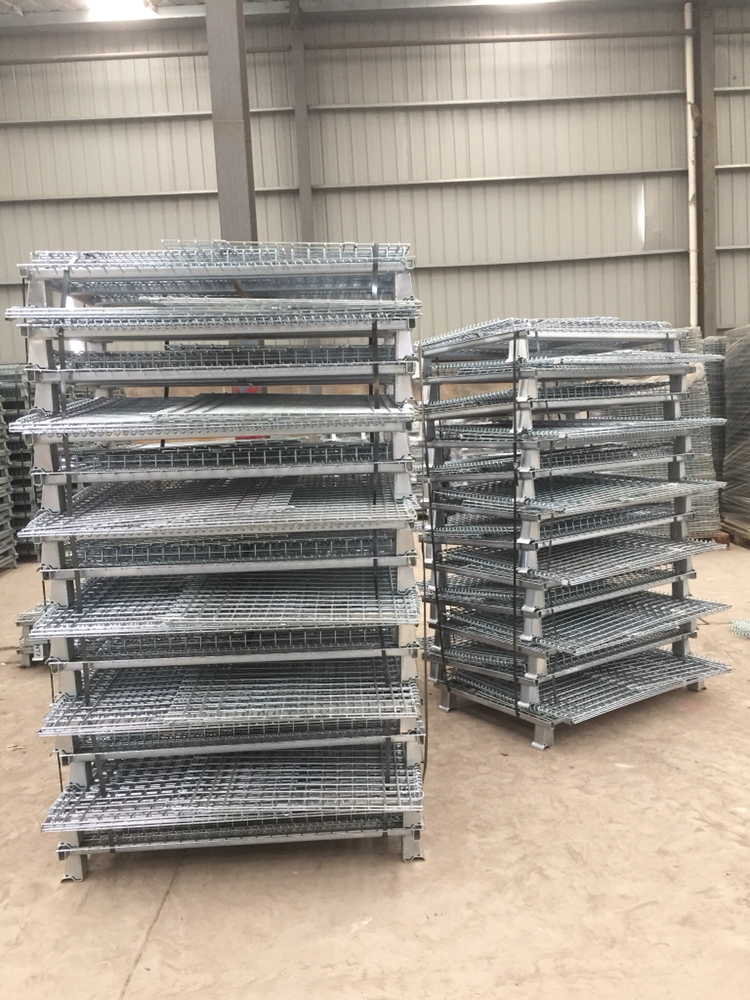 A stack of folded up metal wire mesh storage cage containers